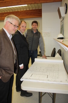 OHS Principal James Trodden, Ryan Bourke from Academy Welding and Architect Dave MacGregor look over the plans for the new school.